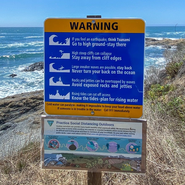 Tsunami Warning sign right next to the ocean/beach