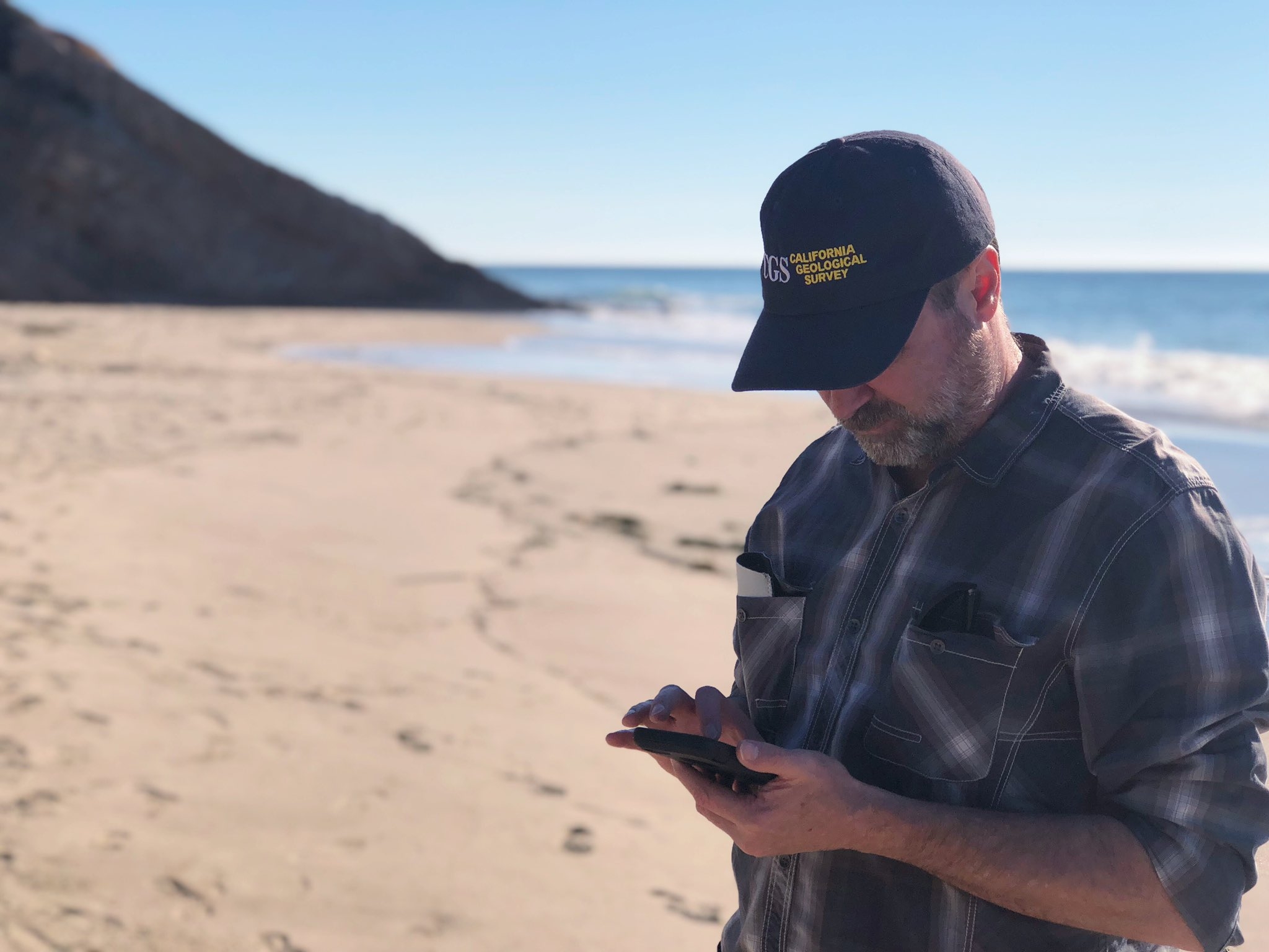 Photo of Mike D. from California Geological Survey collecting tsunami damage evidence in California