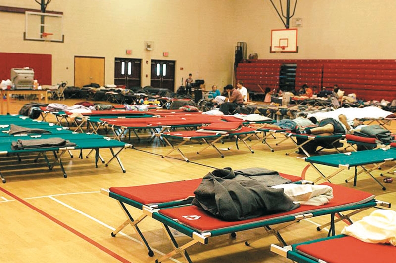 cots in a school gymnasium 